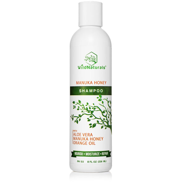 Wild Naturals Manuka Honey Shampoo for dry scalp and hair repair, featuring organic aloe vera and orange oil. 8oz white bottle with green botanical design, pH balanced at 5.5.
